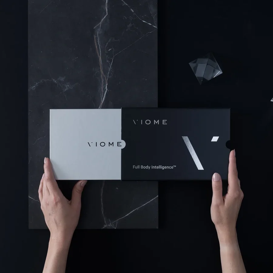 Viome Full Body Intelligence at-home test kit box held in two hands